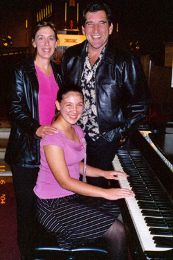 Long Beach piano student Megan Sanford and parents at the Steinway piano in Our Saviour's Lutheran Church