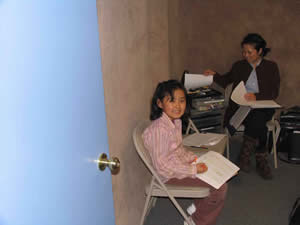 Photo image of piano teacher Lisa Kato Fitchett and student in music theory classroom